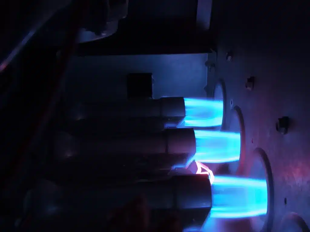 Close-up of clean blue burner flames during furnace burner cleaning and tuning