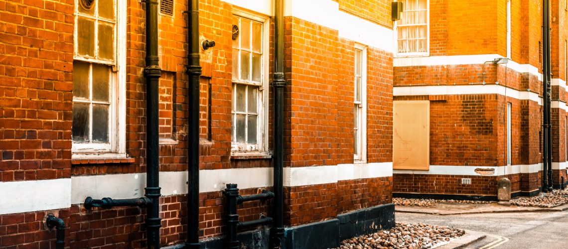 Drain pipe on the red brick wall