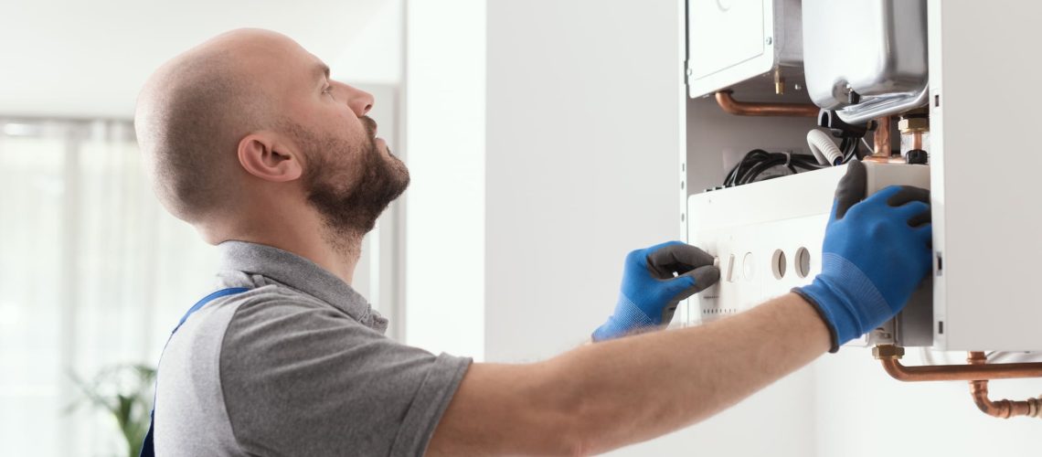 Professional qualified engineer testing a gas boiler after repair
