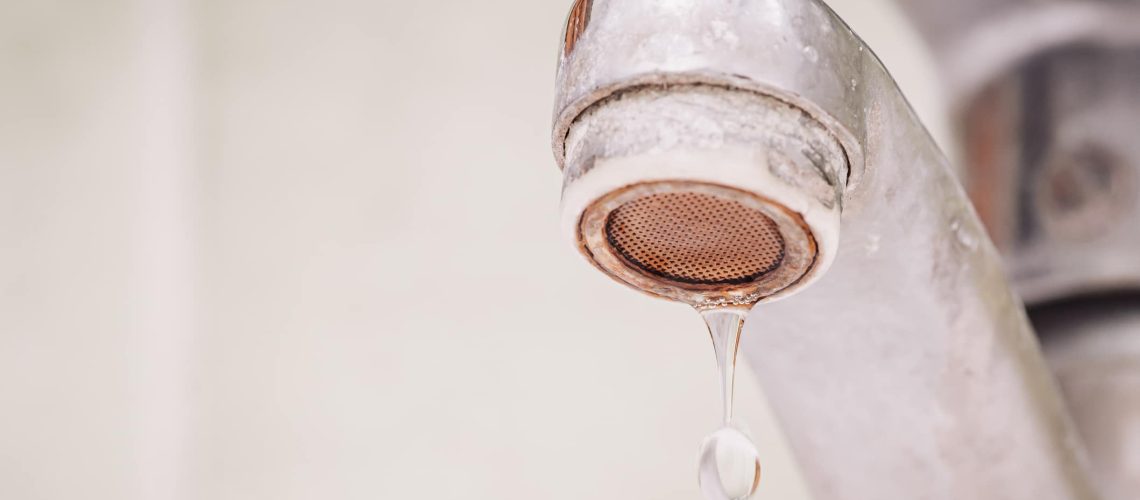 Problems with water, hard water concept, warm toned photo