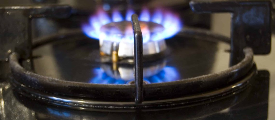 Blue flames on gas stove burner.
